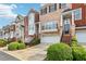 Beautiful brick townhomes with attached garages, steps leading to entrances, and lush landscaping at 1215 Comet View Se Trl, Smyrna, GA 30082