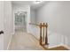Hallway leading to a room with a tray ceiling, featuring wood-trimmed banister at 1215 Comet View Se Trl, Smyrna, GA 30082