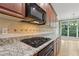 Modern kitchen featuring granite countertops, a gas cooktop, and ample cabinet space at 1215 Comet View Se Trl, Smyrna, GA 30082