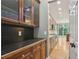 Kitchen with black backsplash, wooden cabinets and stainless steel appliances at 1215 Comet View Se Trl, Smyrna, GA 30082