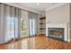 Bright living room showcasing hardwood floors, fireplace, and balcony access at 1215 Comet View Se Trl, Smyrna, GA 30082