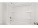 Clean and bright bathroom showcasing a tub and shower combination with white tiling and built-in shelving at 208 Sharon Ln, Loganville, GA 30052