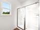 Modern bathroom showing a glass enclosed shower, neutral walls and a window at 208 Sharon Ln, Loganville, GA 30052