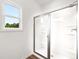 Bathroom featuring a large stand up shower, new glass door, and natural light at 208 Sharon Ln, Loganville, GA 30052