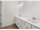 Bathroom vanity with double sinks, white cabinets, and marble countertop at 208 Sharon Ln, Loganville, GA 30052