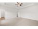A large bedroom featuring neutral carpet and trey ceilings and multiple doors at 208 Sharon Ln, Loganville, GA 30052