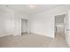 Bright bedroom featuring neutral carpet, a closet, a ceiling light, and access to an upstairs hallway at 208 Sharon Ln, Loganville, GA 30052