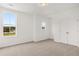 Bright bedroom featuring neutral carpet, natural light, a closet, and access to the rest of the home at 208 Sharon Ln, Loganville, GA 30052