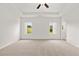 Bright bedroom with plush carpet, tray ceiling, and natural light from two windows at 208 Sharon Ln, Loganville, GA 30052