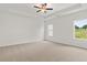 Spacious bedroom with tray ceiling, ceiling fan, plush carpet, and natural light from windows at 208 Sharon Ln, Loganville, GA 30052
