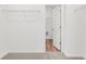 Bright walk-in closet showing shelves, an open door and neutral walls and carpet at 208 Sharon Ln, Loganville, GA 30052