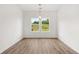 Bright dining area with light-colored hardwood floors, natural light, and views to nature at 208 Sharon Ln, Loganville, GA 30052
