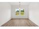 Bright dining area with stylish light fixture and natural light from large windows at 208 Sharon Ln, Loganville, GA 30052