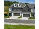 View of new modern townhomes with front garages at 208 Sharon Ln, Loganville, GA 30052