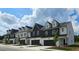 Beautifully designed townhomes featuring private garages, modern architecture and manicured landscaping at 208 Sharon Ln, Loganville, GA 30052