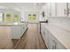 Bright kitchen features white cabinets, quartz countertops, and stainless steel appliances at 208 Sharon Ln, Loganville, GA 30052