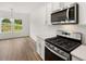 Modern kitchen featuring stainless steel appliances, including a gas range and microwave at 208 Sharon Ln, Loganville, GA 30052