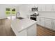 New kitchen features white cabinets, quartz countertops, and stainless steel appliances at 208 Sharon Ln, Loganville, GA 30052