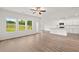 Bright, open living space with large windows and vinyl floors seamlessly integrates with the kitchen at 208 Sharon Ln, Loganville, GA 30052