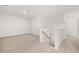 Spacious upstairs loft with neutral carpet, a stairwell, and access to the home's bedrooms at 208 Sharon Ln, Loganville, GA 30052