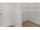Walk-in pantry with adjustable wire shelving and luxury vinyl plank flooring at 208 Sharon Ln, Loganville, GA 30052