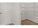 New home features a convenient walk-in pantry with wooden floor and wired shelving for organized storage at 208 Sharon Ln, Loganville, GA 30052