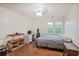 This bedroom features wood floors, a ceiling fan, two windows, and a desk at 435 Trammell Dr, Alpharetta, GA 30009