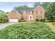 Charming two-story brick home featuring well-manicured landscaping, a two-car garage and inviting front entrance at 435 Trammell Dr, Alpharetta, GA 30009