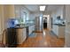 Well-lit kitchen featuring white cabinetry, stainless steel appliances, and hardwood floors at 435 Trammell Dr, Alpharetta, GA 30009