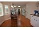 Eat-in kitchen featuring white cabinetry, stainless steel appliances, and hardwood floors at 435 Trammell Dr, Alpharetta, GA 30009