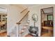View of carpeted staircase with wooden railing, complemented by decorative furniture and hardwood flooring at 435 Trammell Dr, Alpharetta, GA 30009