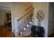 Elegant staircase featuring hardwood floors, a decorative chest, and a stylish round mirror at 435 Trammell Dr, Alpharetta, GA 30009