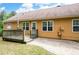 Back patio with brick pavers, wooden deck, and exterior of house with brown siding at 55 Cross Pointe Ct, Hiram, GA 30141