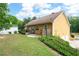 Exterior view of home showing backyard with lawn, patio, and lush surrounding greenery at 55 Cross Pointe Ct, Hiram, GA 30141