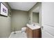 Powder room with wood vanity and a modern toilet, enhanced by the paint color at 55 Cross Pointe Ct, Hiram, GA 30141