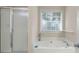 Bright bathroom features a soaking tub, shower, and a window for natural light at 55 Cross Pointe Ct, Hiram, GA 30141
