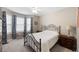 Bedroom featuring a metal frame bed, bay window with drapes, and plush carpeting at 55 Cross Pointe Ct, Hiram, GA 30141