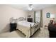 Cozy bedroom with an iron frame bed, side tables, and neutral-colored walls with natural light at 55 Cross Pointe Ct, Hiram, GA 30141