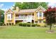 Charming two-story home featuring a welcoming front porch, landscaped yard, and a warm, inviting facade at 55 Cross Pointe Ct, Hiram, GA 30141