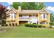 Charming two-story home featuring a welcoming front porch, landscaped yard, and a warm, inviting facade at 55 Cross Pointe Ct, Hiram, GA 30141