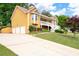 Charming two-story home with a three-car garage, green lawn, and mature trees at 55 Cross Pointe Ct, Hiram, GA 30141