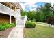 Beautiful landscaped yard and walkway leading to a charming two-story home featuring a welcoming front porch at 55 Cross Pointe Ct, Hiram, GA 30141