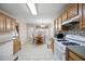 Kitchen featuring wood cabinets, white appliances, and tile backsplash at 55 Cross Pointe Ct, Hiram, GA 30141