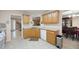 Well-lit kitchen with wood cabinets, tile floor, and white appliances at 55 Cross Pointe Ct, Hiram, GA 30141