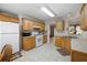 Bright kitchen featuring wooden cabinetry, white appliances, and neutral countertops at 55 Cross Pointe Ct, Hiram, GA 30141