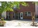 Backyard featuring a brick house, a patio, and some manicured greenery at 601 Hexham Ct, Suwanee, GA 30024