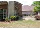 Backyard featuring a brick house, fenced area, and lush green grass at 601 Hexham Ct, Suwanee, GA 30024