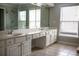 A primary bathroom featuring double sinks, vanity, and a walk-in shower with glass enclosure at 601 Hexham Ct, Suwanee, GA 30024