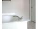 Close up of bathroom soaking tub, with stylish fixtures and tile flooring at 601 Hexham Ct, Suwanee, GA 30024