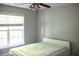 Comfortable bedroom featuring a ceiling fan, window with natural light and neutral walls at 601 Hexham Ct, Suwanee, GA 30024